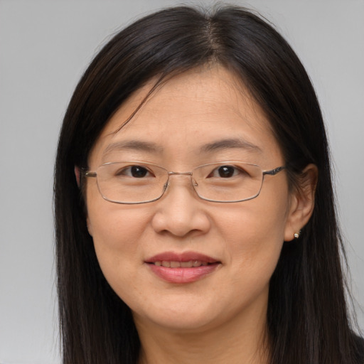 Joyful white adult female with long  brown hair and brown eyes