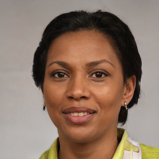 Joyful latino adult female with medium  black hair and brown eyes
