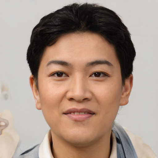 Joyful asian young-adult female with short  black hair and brown eyes