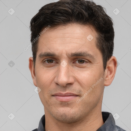 Joyful white adult male with short  brown hair and brown eyes