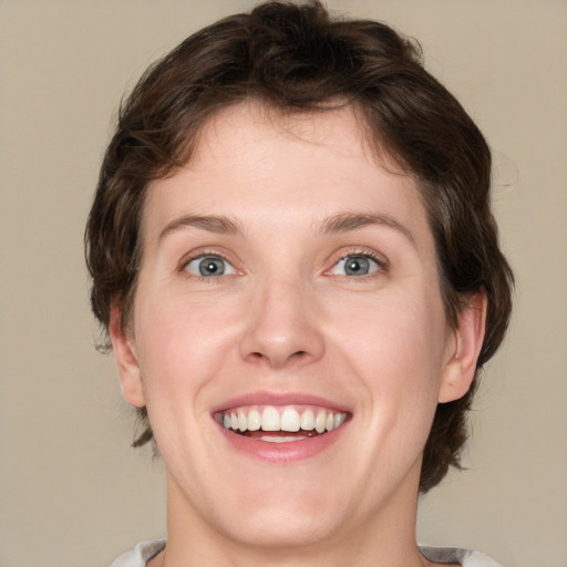 Joyful white young-adult female with medium  brown hair and green eyes