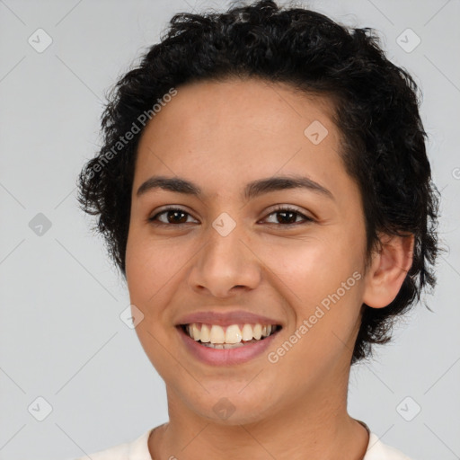 Joyful latino young-adult female with short  brown hair and brown eyes