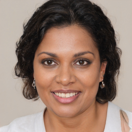 Joyful black young-adult female with medium  brown hair and brown eyes