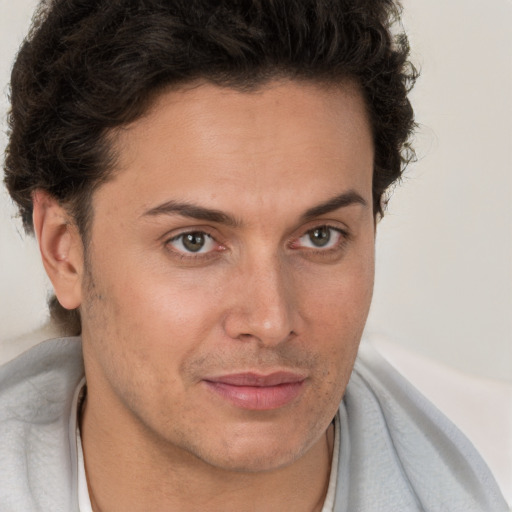 Joyful white adult male with short  brown hair and brown eyes