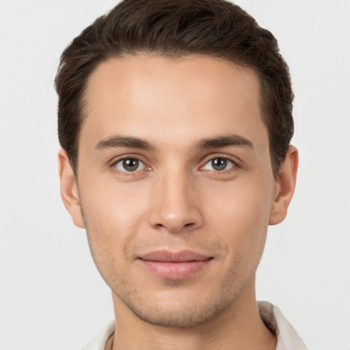 Joyful white young-adult male with short  brown hair and brown eyes