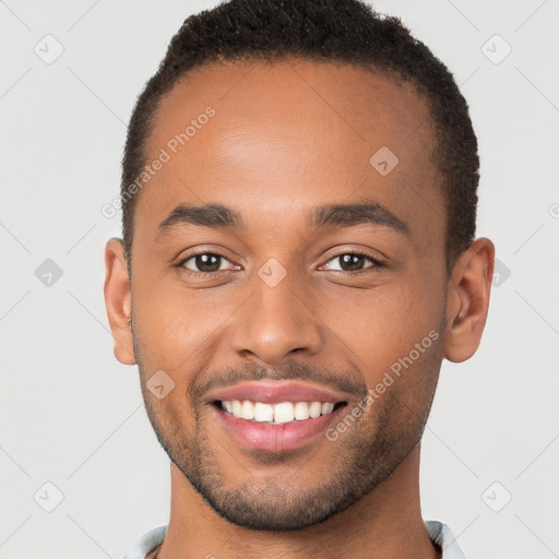 Joyful black young-adult male with short  brown hair and brown eyes