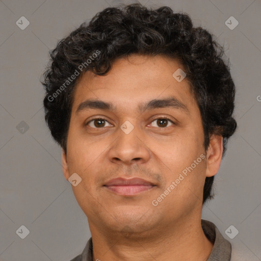 Joyful latino young-adult male with short  brown hair and brown eyes