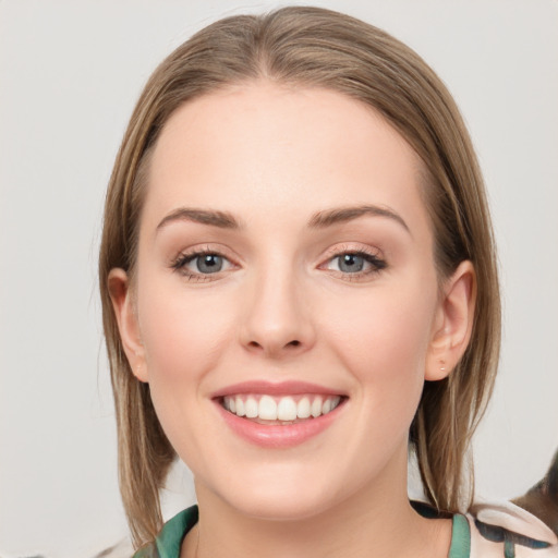 Joyful white young-adult female with medium  brown hair and blue eyes