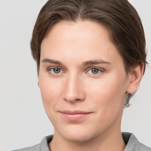 Joyful white young-adult female with short  brown hair and grey eyes