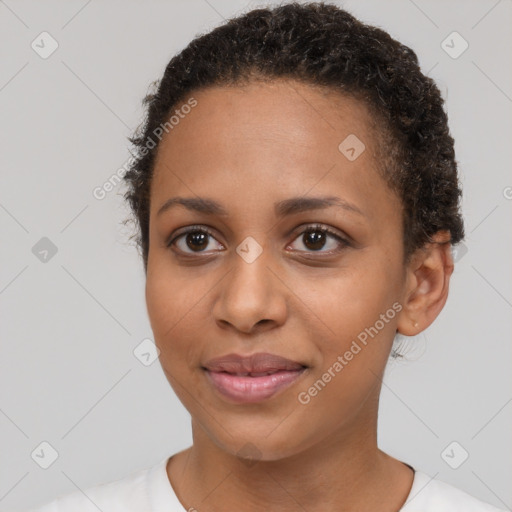 Joyful black young-adult female with short  brown hair and brown eyes