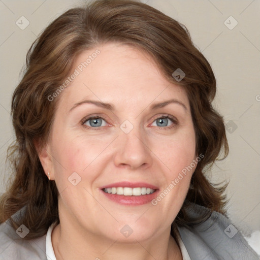 Joyful white adult female with medium  brown hair and blue eyes