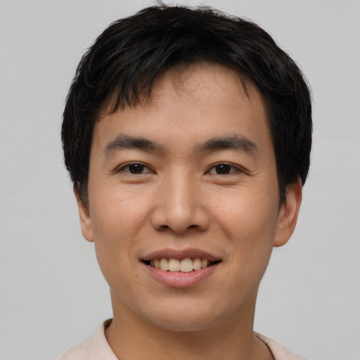 Joyful asian young-adult male with short  brown hair and brown eyes