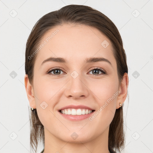 Joyful white young-adult female with medium  brown hair and grey eyes