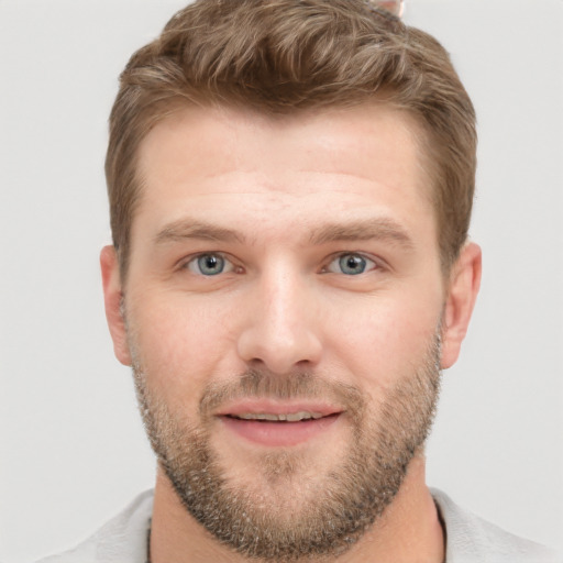 Joyful white young-adult male with short  brown hair and grey eyes