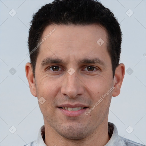 Joyful white adult male with short  brown hair and brown eyes