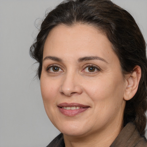 Joyful white adult female with medium  brown hair and brown eyes