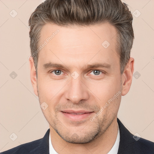 Joyful white adult male with short  brown hair and brown eyes