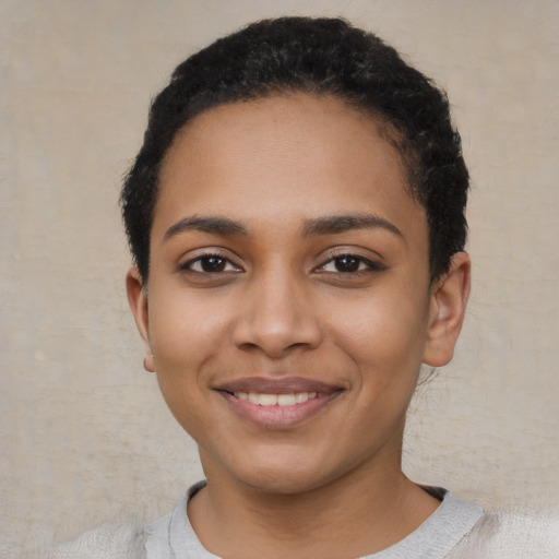 Joyful latino young-adult female with short  black hair and brown eyes