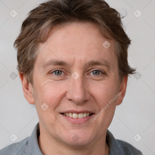 Joyful white adult male with short  brown hair and grey eyes