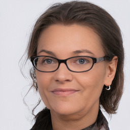 Joyful white adult female with medium  brown hair and brown eyes