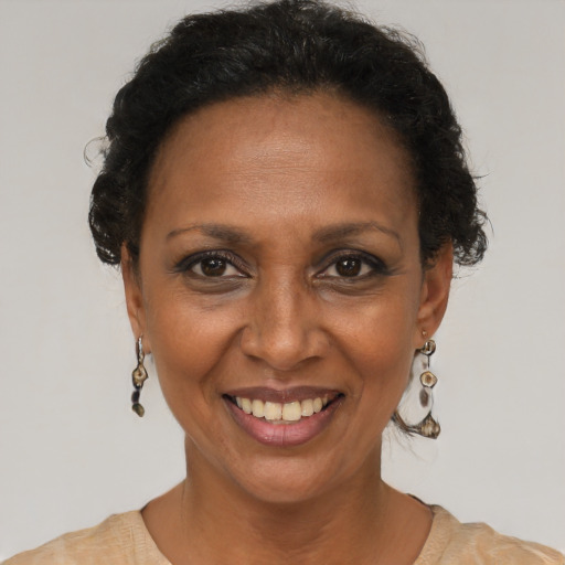 Joyful black adult female with short  brown hair and brown eyes