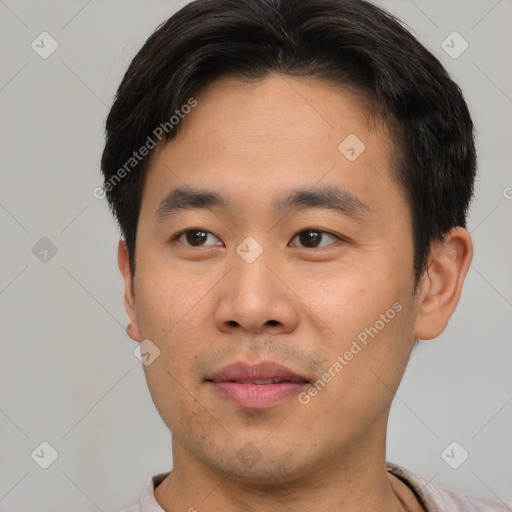 Joyful asian young-adult male with short  brown hair and brown eyes