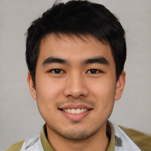 Joyful asian young-adult male with short  black hair and brown eyes