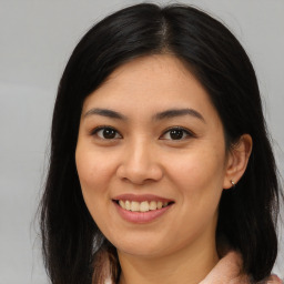 Joyful asian young-adult female with long  brown hair and brown eyes