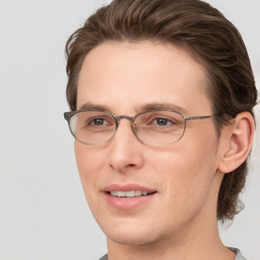 Joyful white adult male with short  brown hair and grey eyes