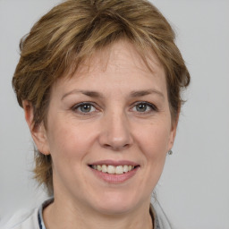 Joyful white adult female with medium  brown hair and grey eyes