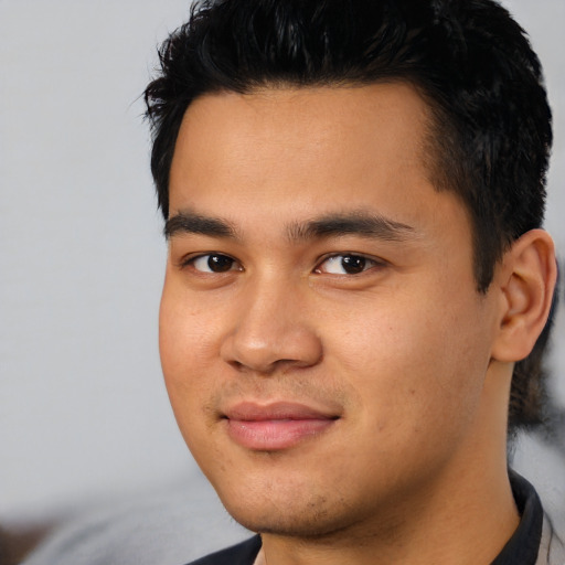 Joyful asian young-adult male with short  black hair and brown eyes