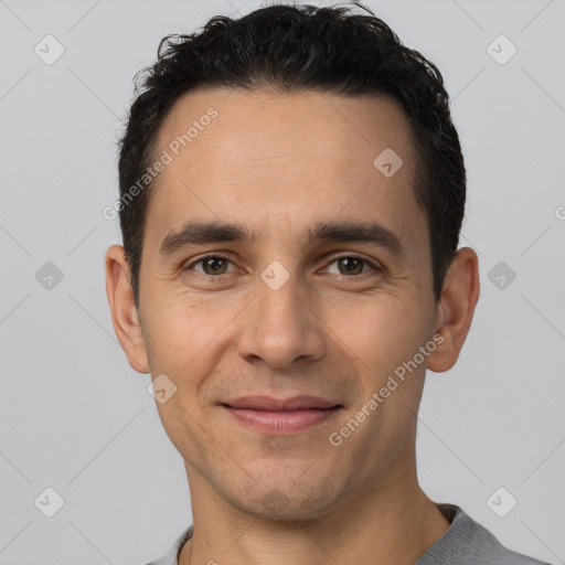 Joyful white young-adult male with short  black hair and brown eyes