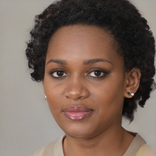 Joyful black young-adult female with medium  black hair and brown eyes