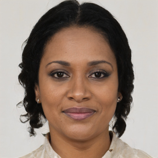 Joyful black adult female with medium  brown hair and brown eyes