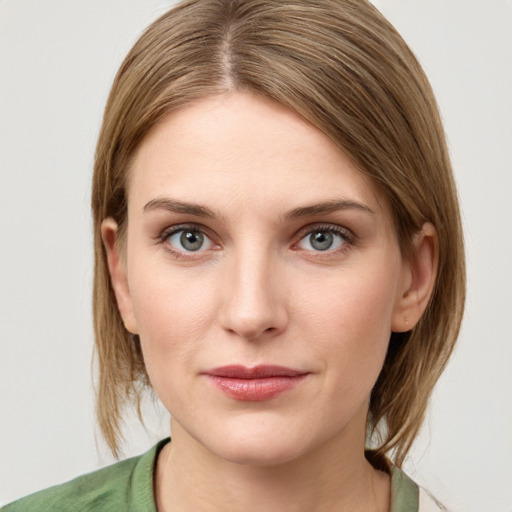 Joyful white young-adult female with medium  brown hair and green eyes