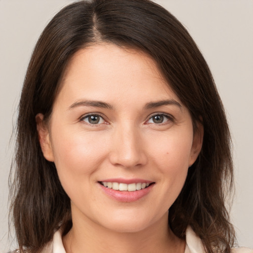 Joyful white young-adult female with medium  brown hair and brown eyes