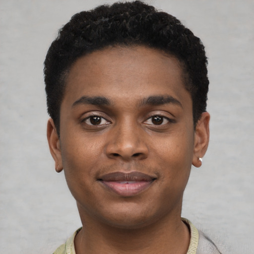 Joyful black young-adult male with short  black hair and brown eyes