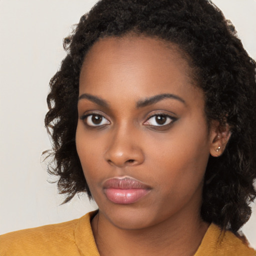 Neutral black young-adult female with medium  brown hair and brown eyes