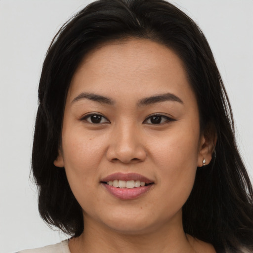 Joyful asian young-adult female with long  brown hair and brown eyes