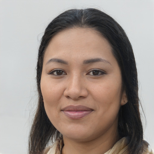 Joyful latino young-adult female with long  brown hair and brown eyes