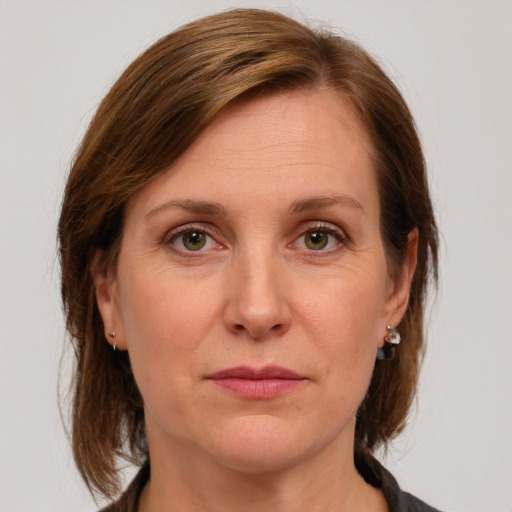 Joyful white adult female with medium  brown hair and grey eyes