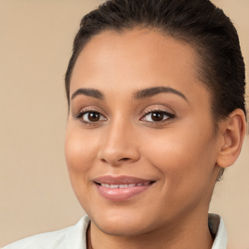 Joyful latino young-adult female with short  brown hair and brown eyes