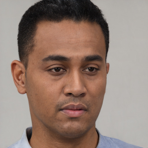 Neutral latino young-adult male with short  black hair and brown eyes