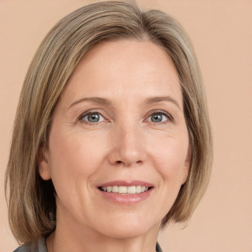 Joyful white adult female with medium  brown hair and grey eyes