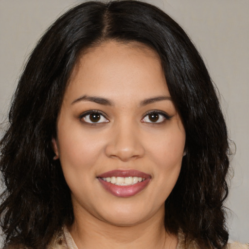Joyful latino young-adult female with medium  brown hair and brown eyes