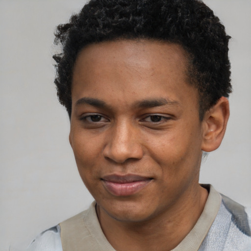 Joyful black young-adult male with short  brown hair and brown eyes
