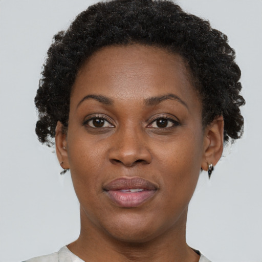 Joyful black adult female with short  brown hair and brown eyes