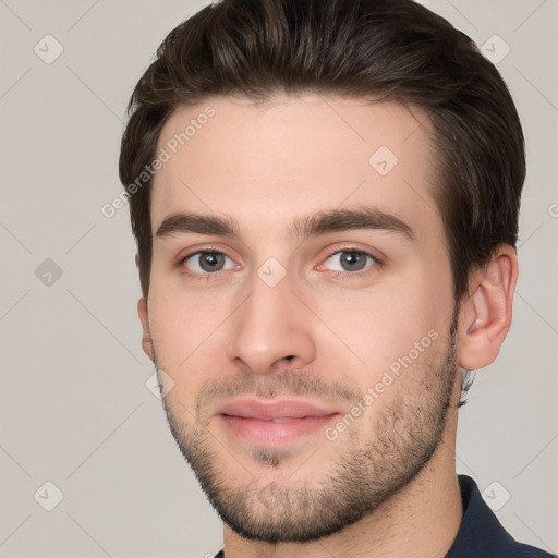 Joyful white young-adult male with short  brown hair and brown eyes