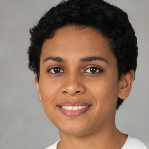 Joyful latino young-adult female with short  black hair and brown eyes