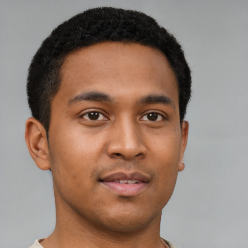 Joyful latino young-adult male with short  brown hair and brown eyes